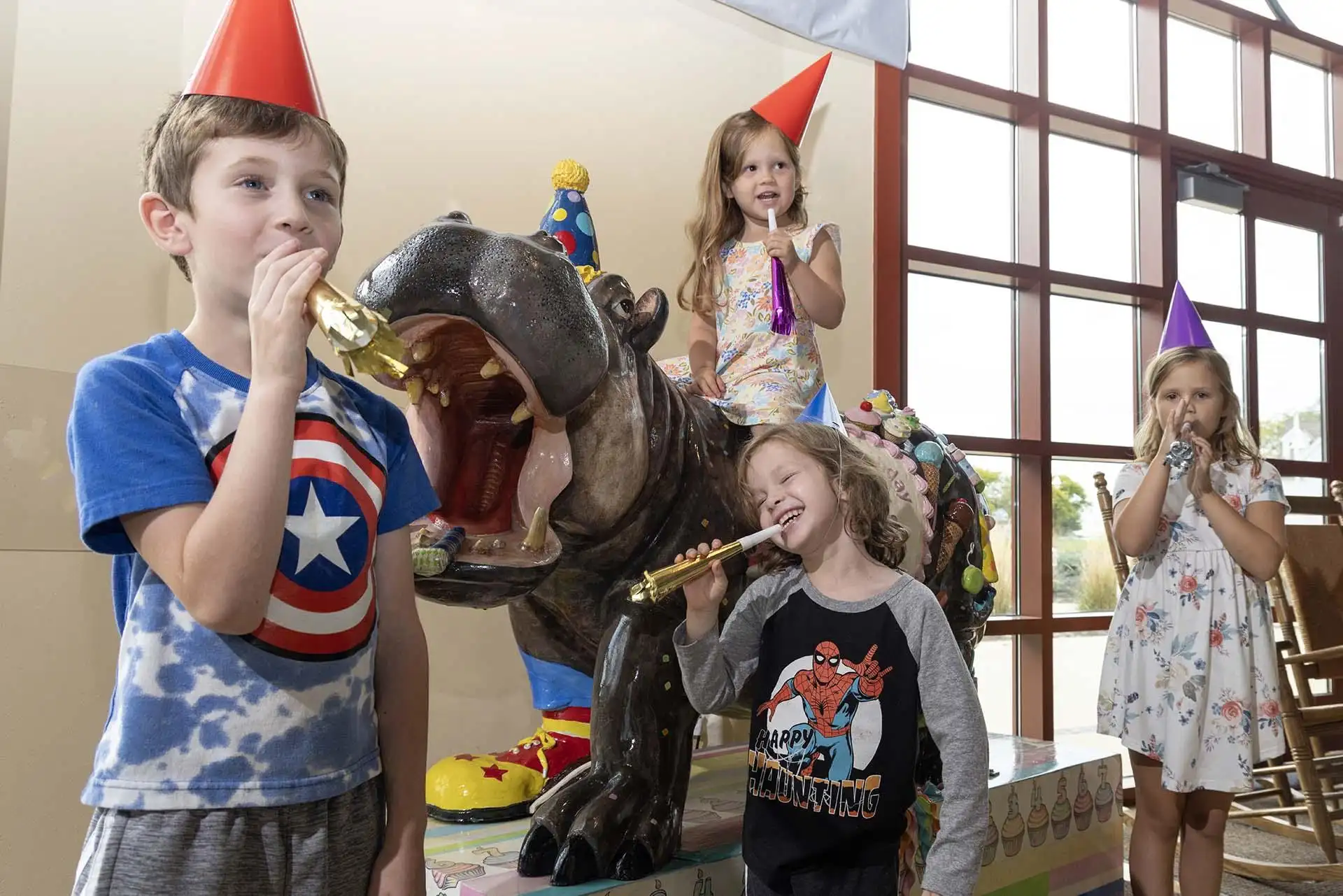 Kids wearing party hats.